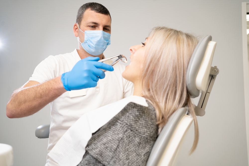 woman,patient,in,dental,clinic.,a,dentist,in,blue,latex